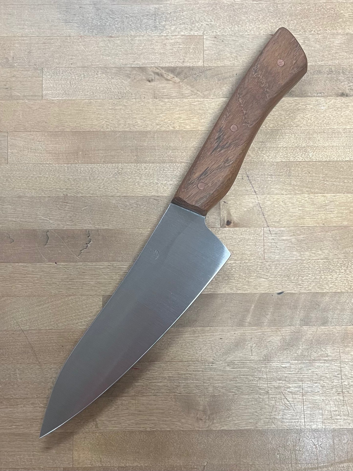 Knife with a wooden handle on a wooden surface