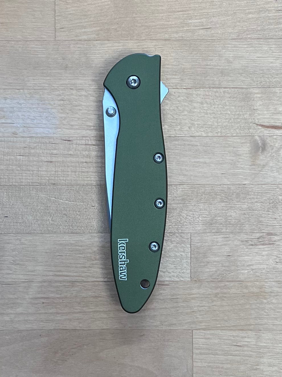 Olive Leek knife on cutting board.