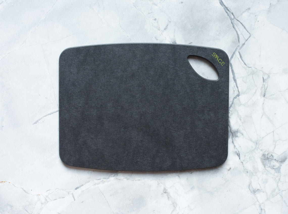 Slate cutting board with 'SAGE' branding on a marble surface