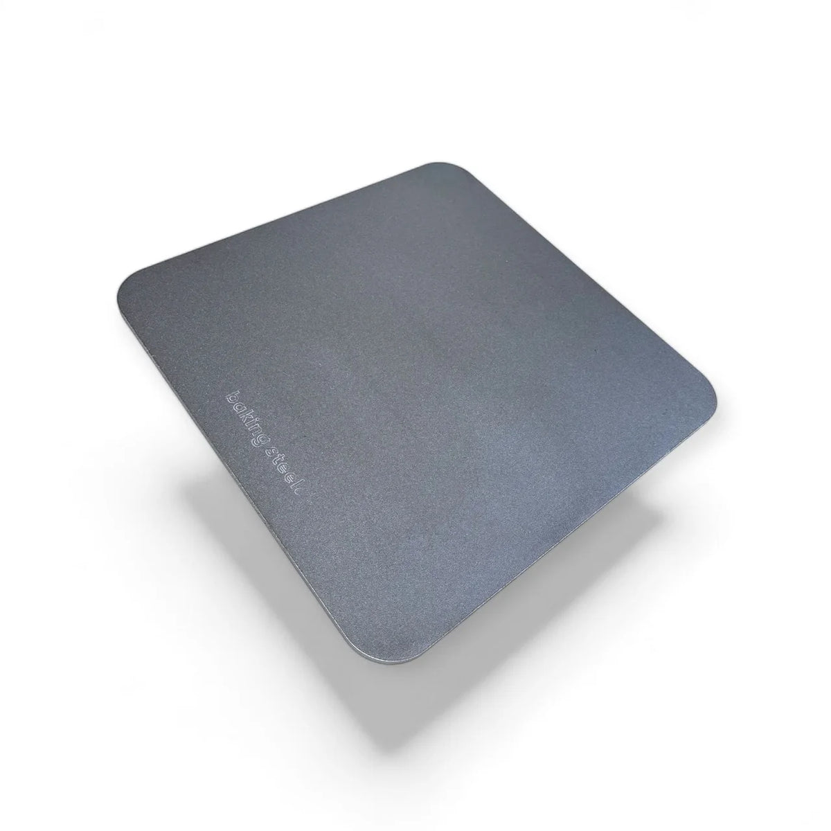 A square dark gray carbon baking steel with rounded corners and the brand name 'baking steel' printed in light gray near the bottom center, shown on a white background with a soft drop shadow.