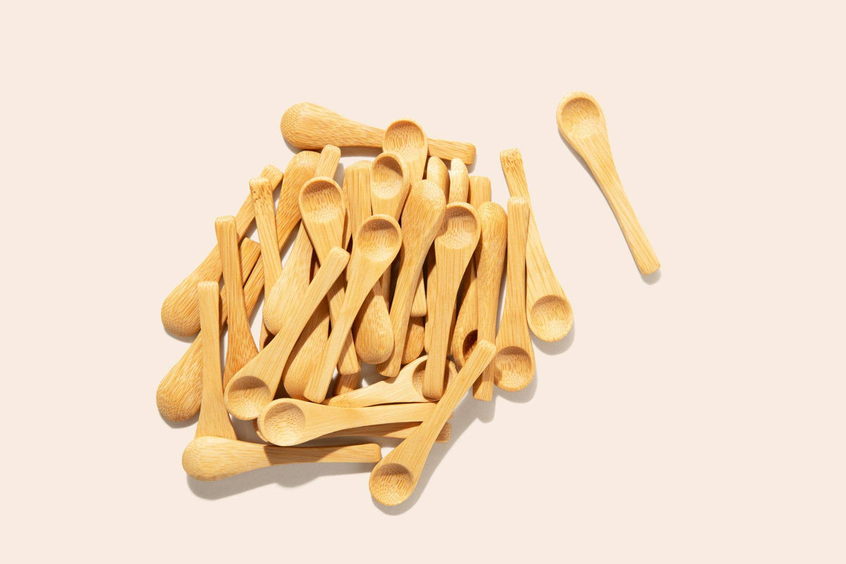 Wooden spoons scattered on a beige background
