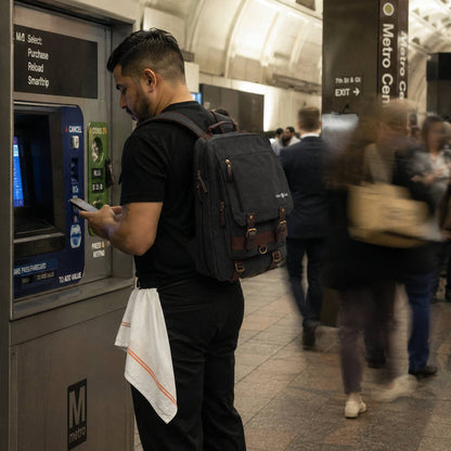 Chef with a backpack using an ATM machine in a busy subway station.