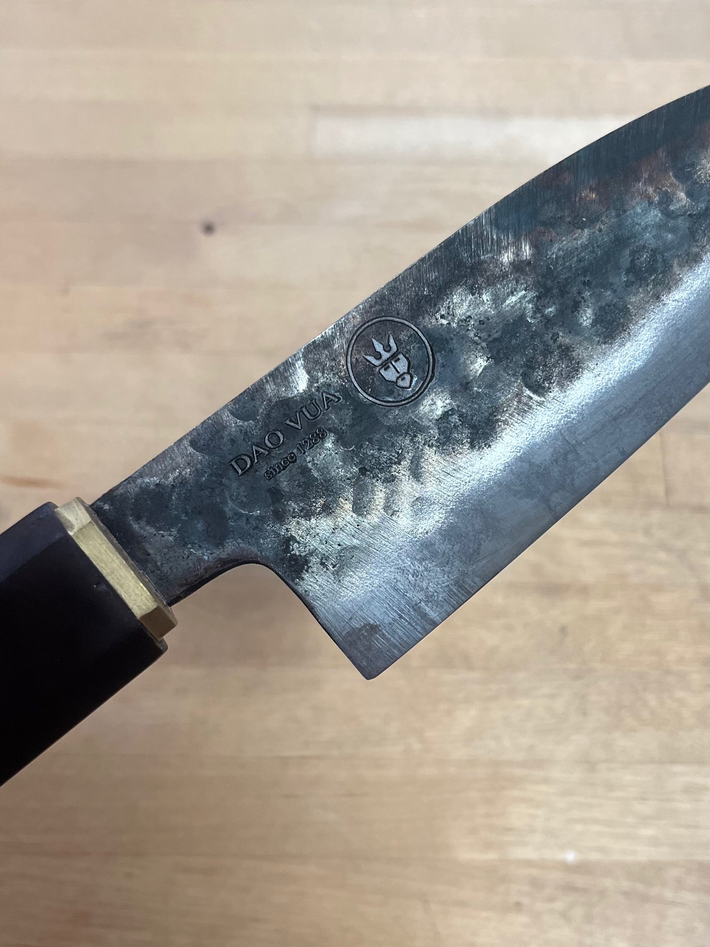 Close-up of a Dao Vua knife with the maker's mark brand logo in view