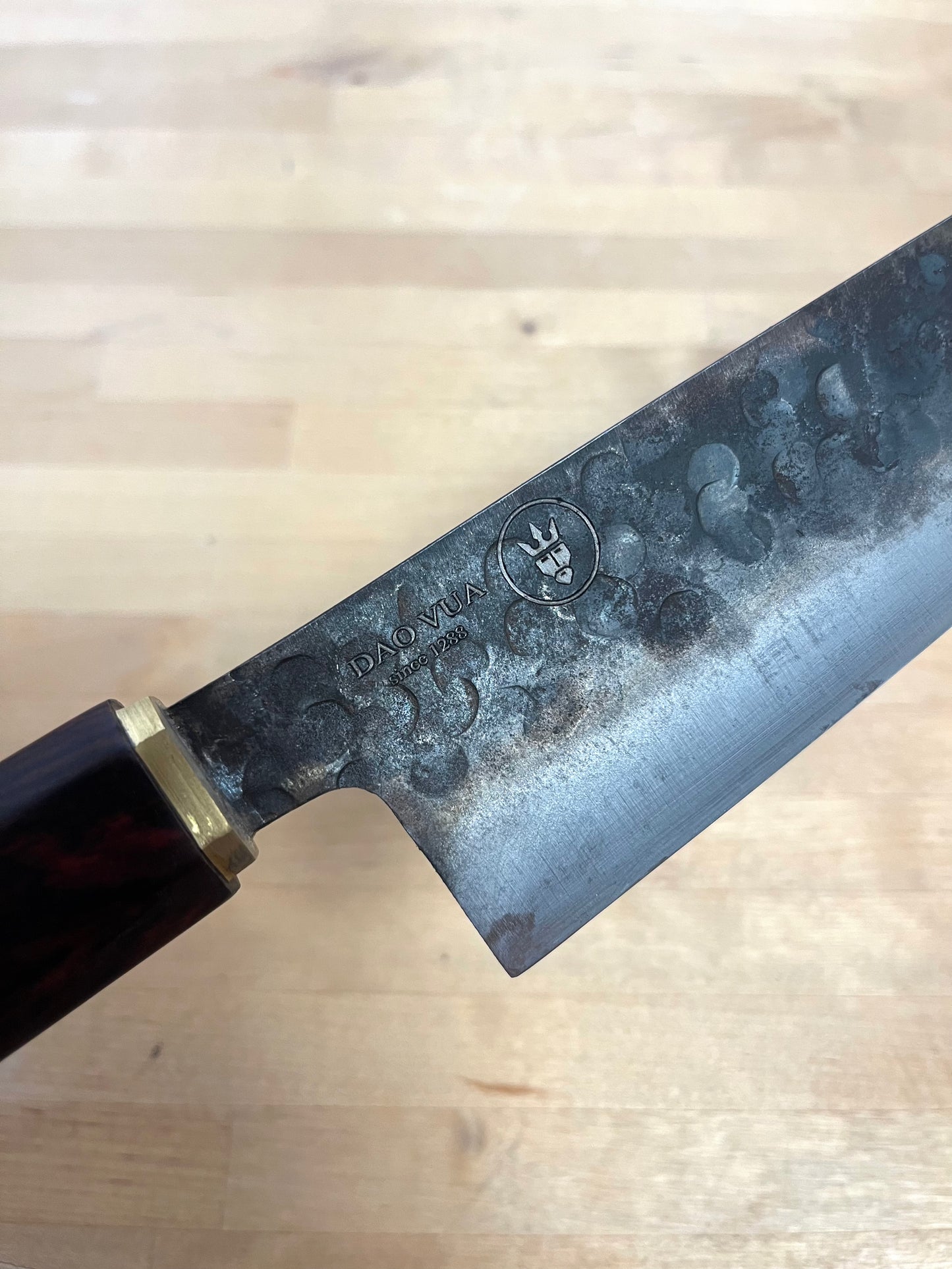 Close-up of a Dao Vua knife blade with a maker's mark brand 