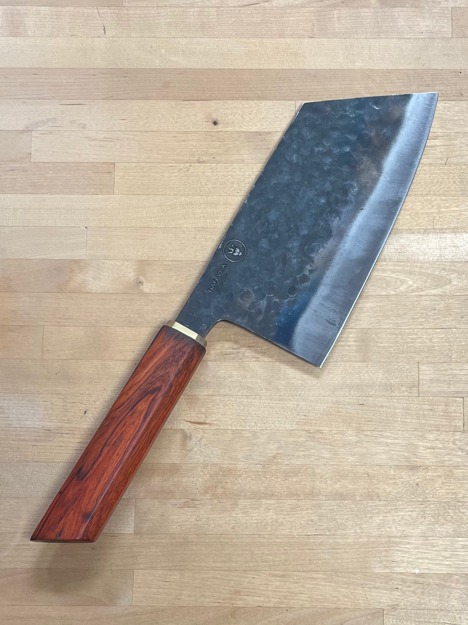 Dao Vua knife with a rosewood handle on a cutting board