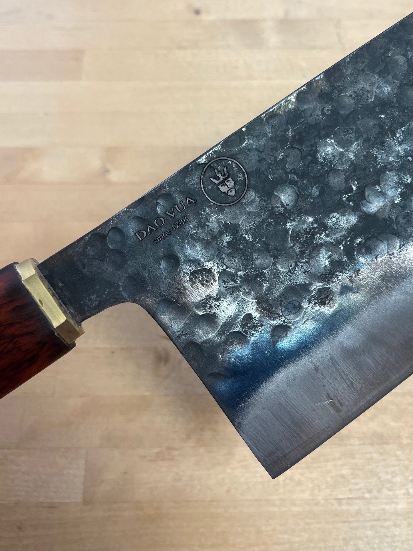 Close-up of a Dao Vua knife with a maker's mark logo
