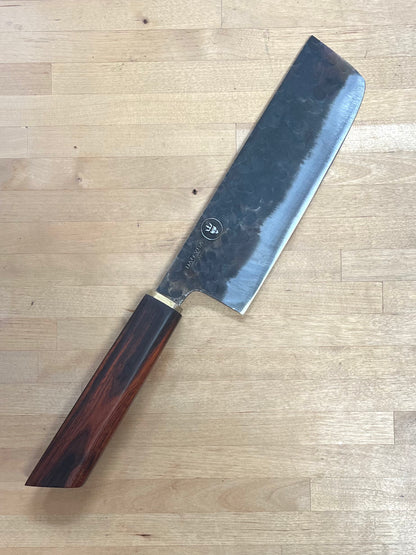 Dao Vua knife with a rosewood handle on a cutting board