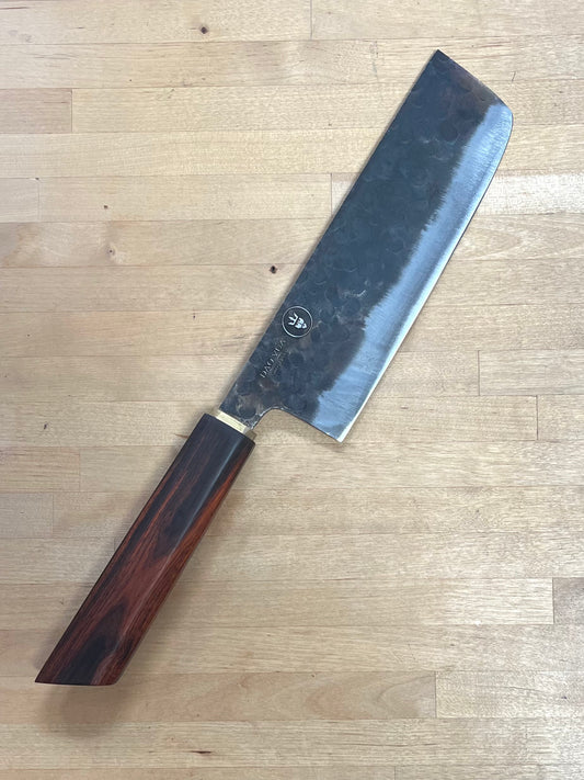 Dao Vua knife with a rosewood handle on a cutting board