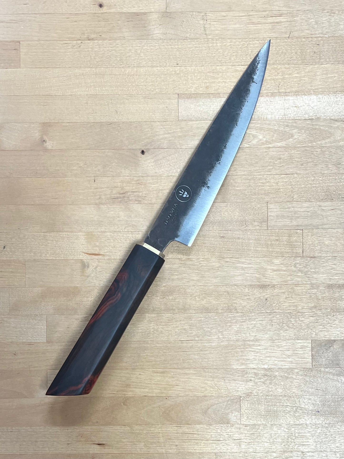 Dao Vua knife with a rosewood handle on a cutting board