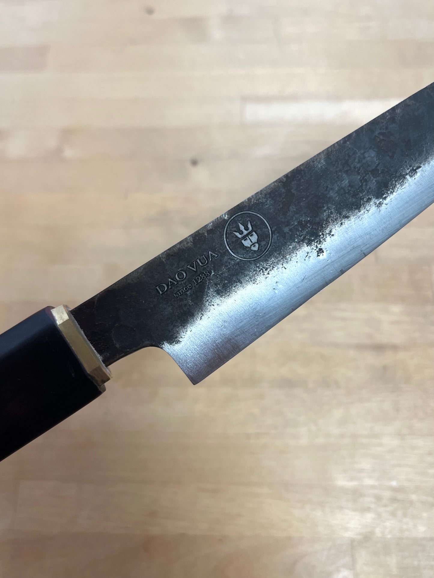 close up of a Dao Vua knife blade with a maker's mark brand 