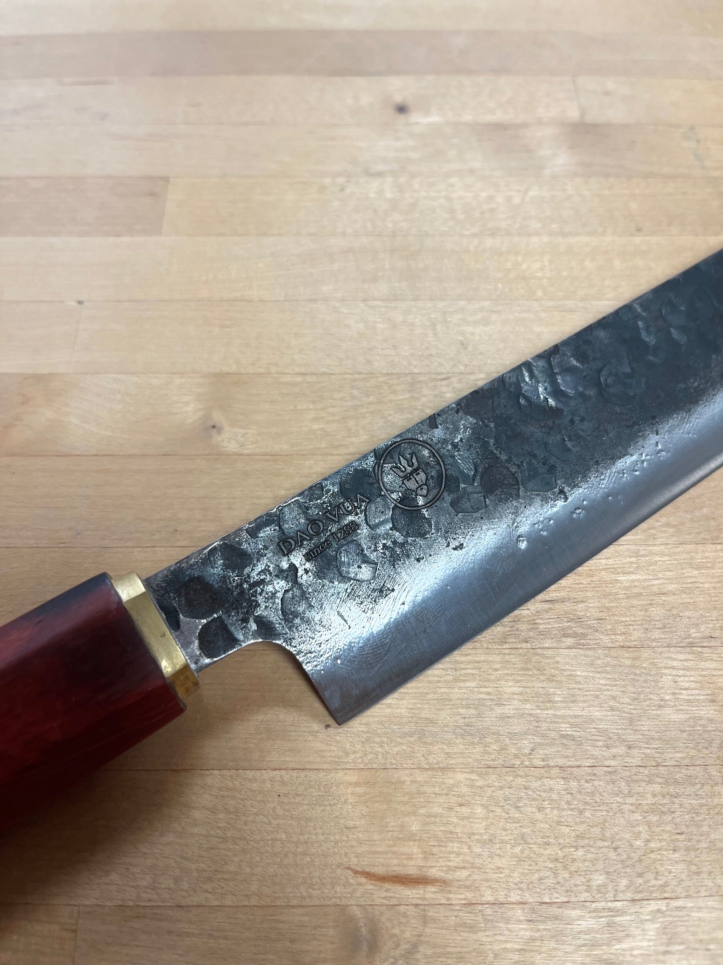 Close up of a Dao Vua knife with a maker's mark brand 