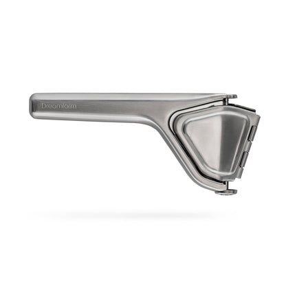 A stainless steel Fluicer with a long handle, shown floating against a light gray background with a soft shadow underneath. The brand name 'Dreamfarm' is subtly engraved on the handle.