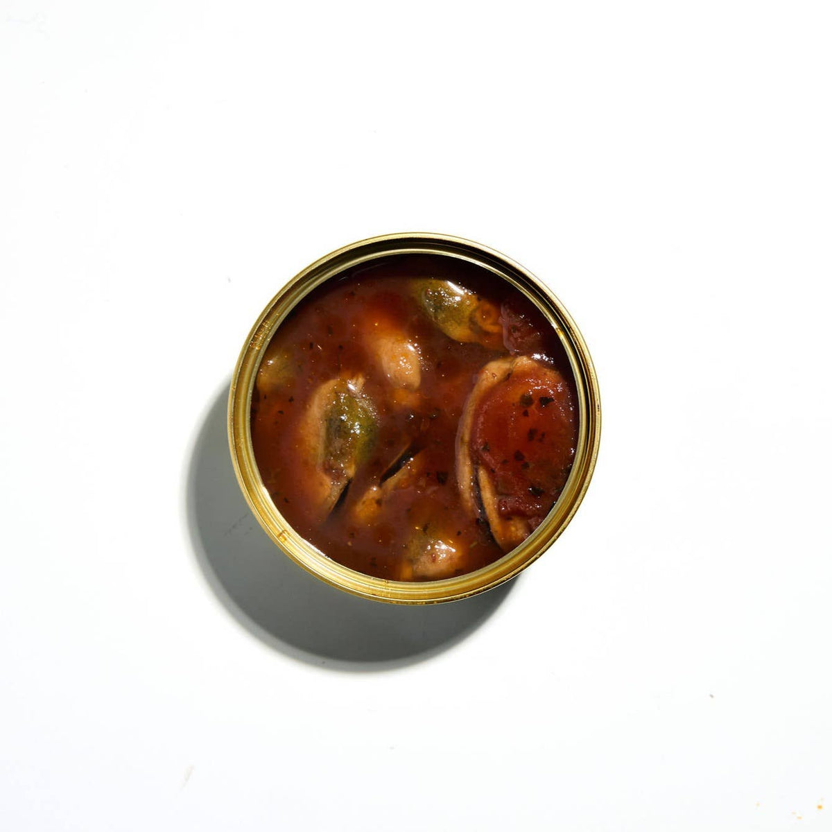 Canned food with a gold lid on a white background