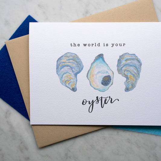 Card with oyster illustrations and 'the world is your oyster' text on a marble surface.