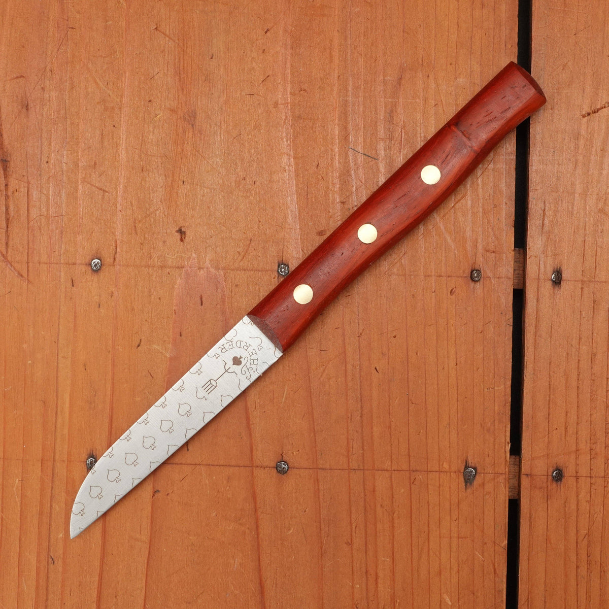 Knife with a wooden handle on a wooden surface