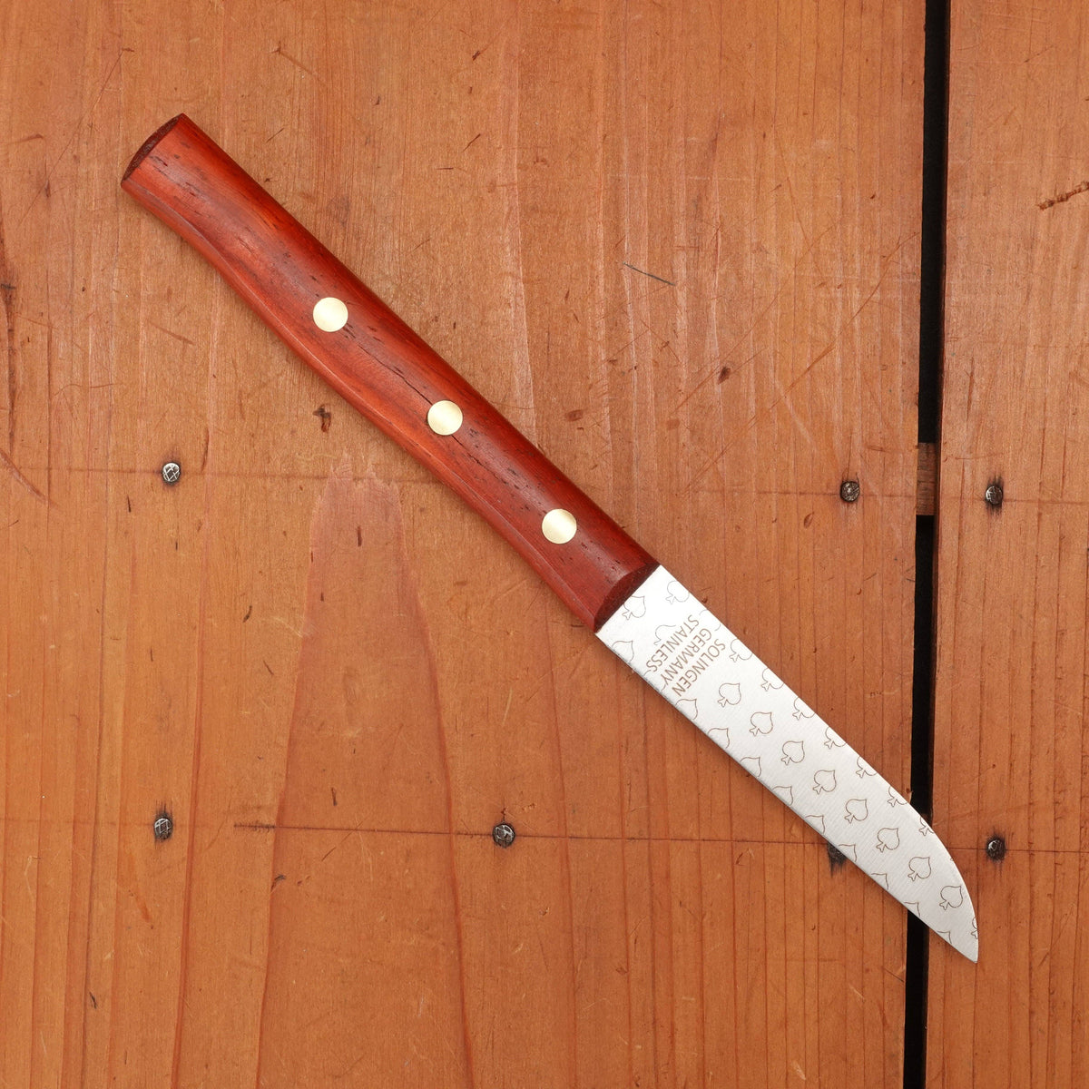 Knife with a wooden handle on a wooden surface