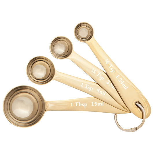 Set of gold measuring spoons on a white background