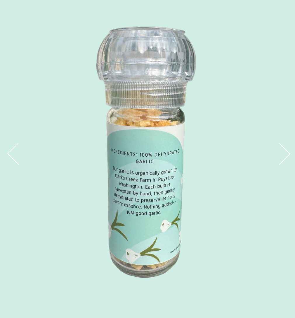 Clear spice jar with a label on a light green background