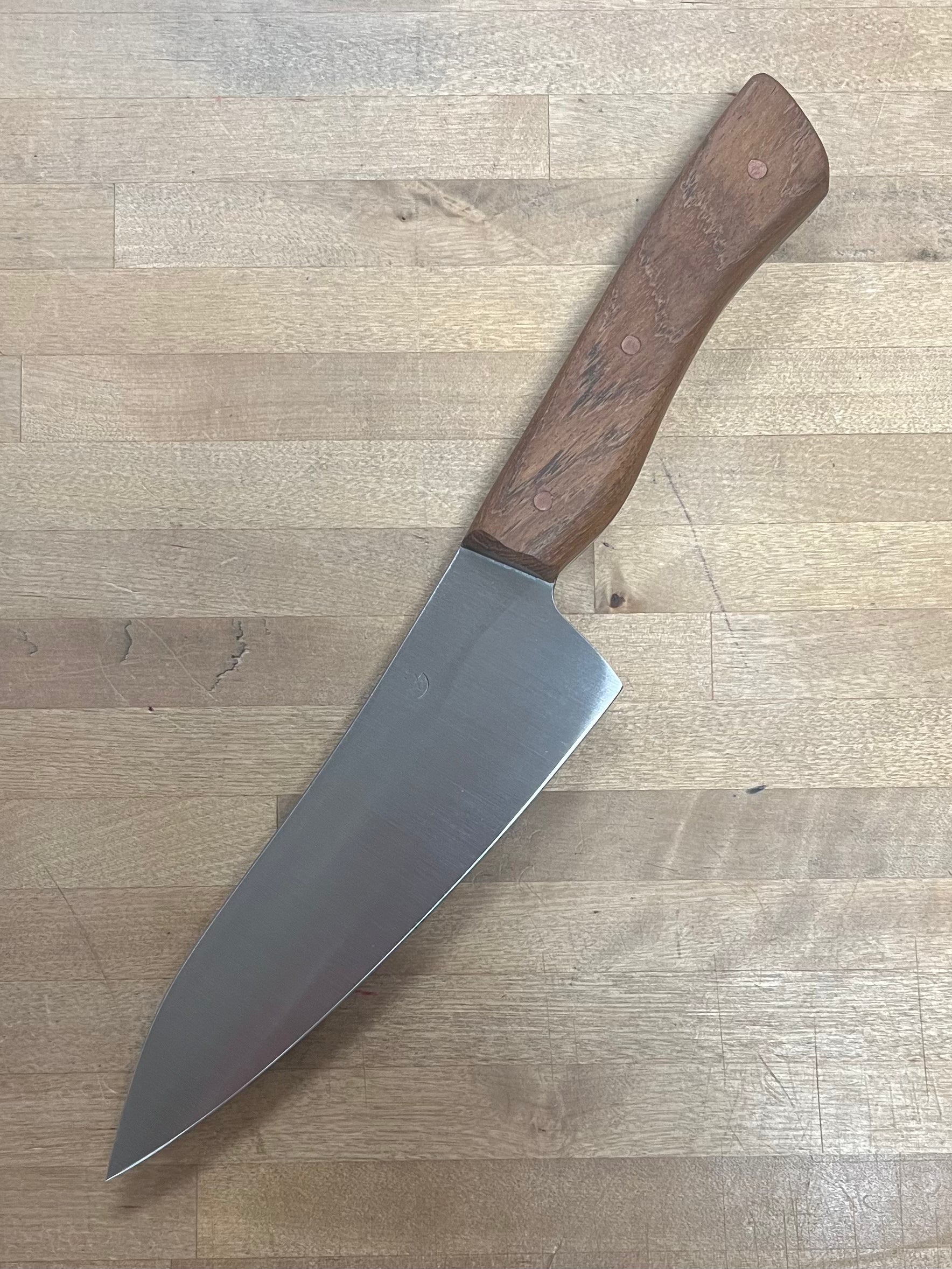 Knife with a wooden handle on a wooden surface
