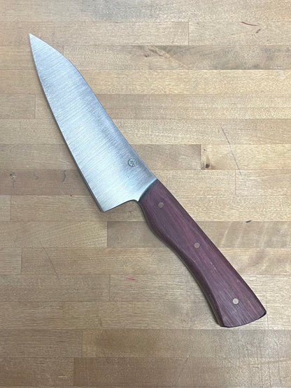 Knife with a wooden handle on a wooden surface