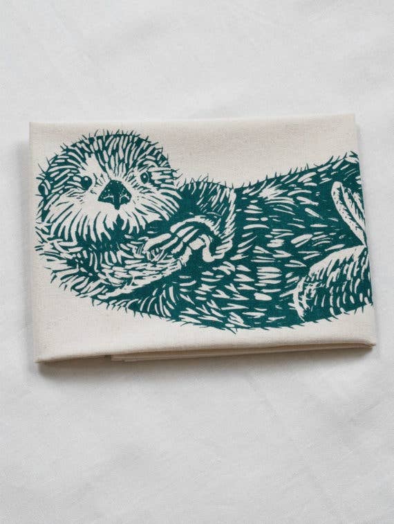 Notebook with teal otter illustration on a white background