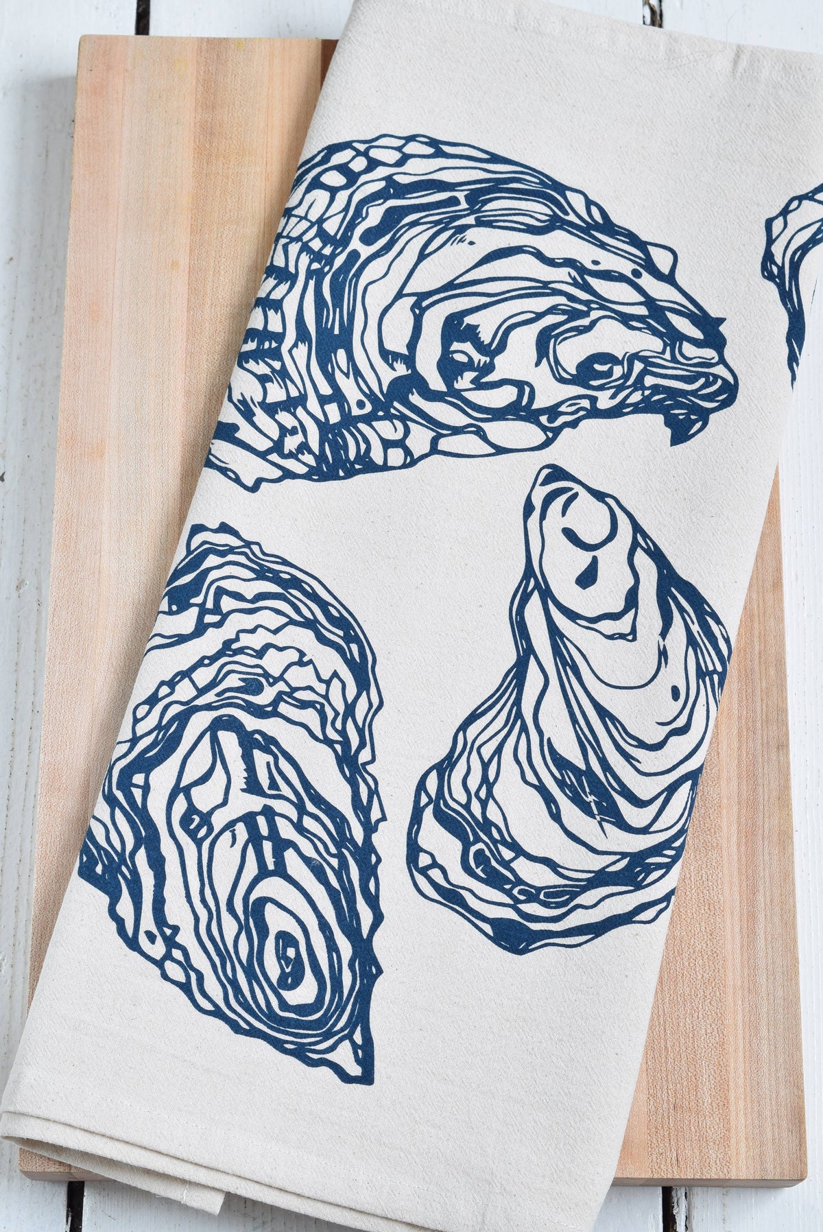 Towel with oyster design on a wooden surface
