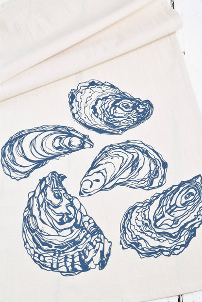 White tea towel with blue oyster prints.