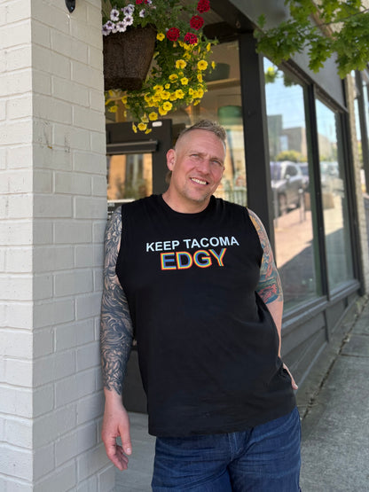 Stephen wearing a black t-shirt with 'KEEP TACOMA EDGY' text, standing outside of The Merc.