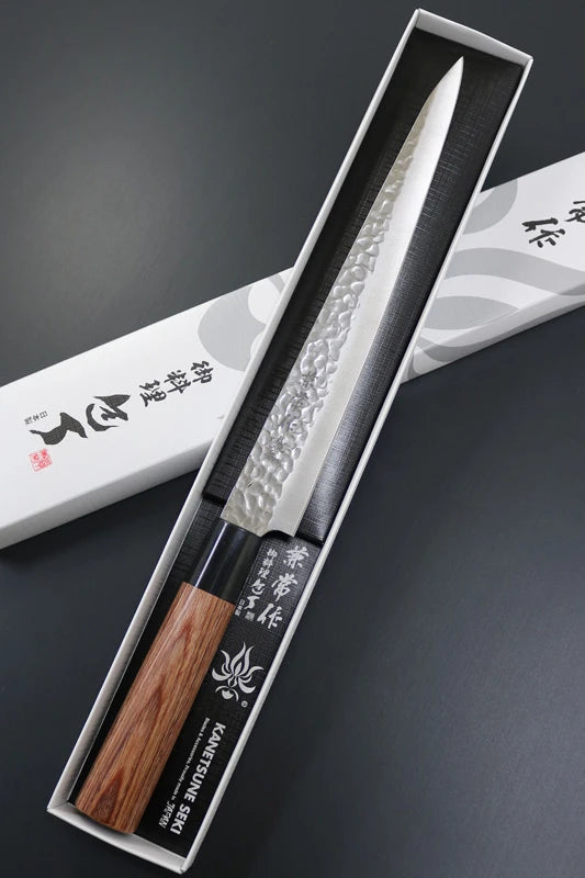 Japanese knife with wooden handle in a black box on a dark background