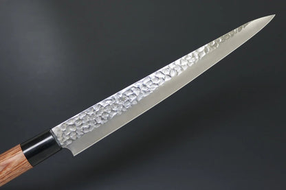 Japanese knife with a textured blade on a dark background
