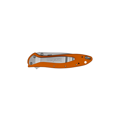 An orange folding pocket knife with a brushed silver metal clip point blade, shown open against a solid white background. The brand 'Kershaw' is clearly visible on the blade.