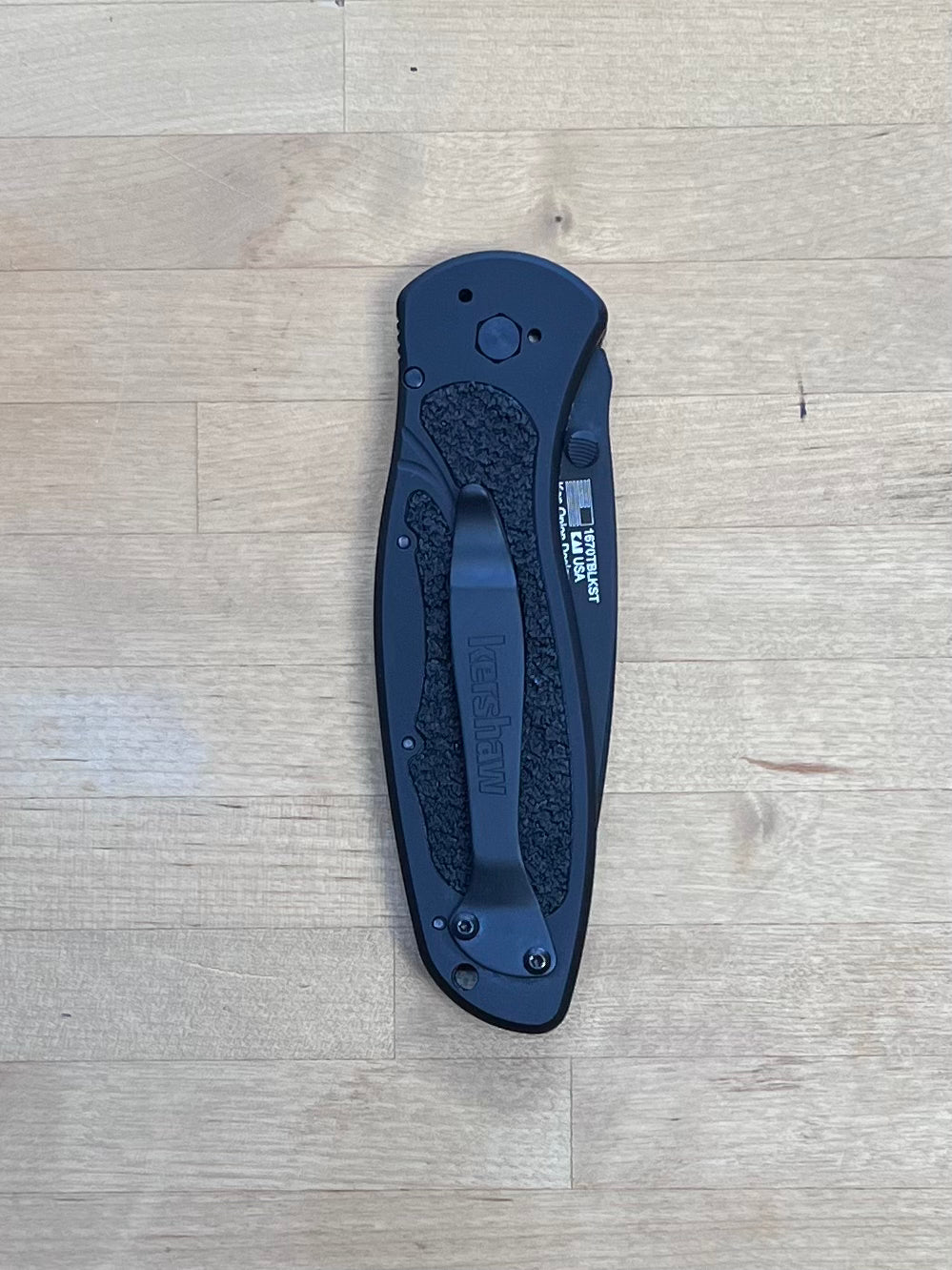 Black Kershaw Blur on cutting board.
