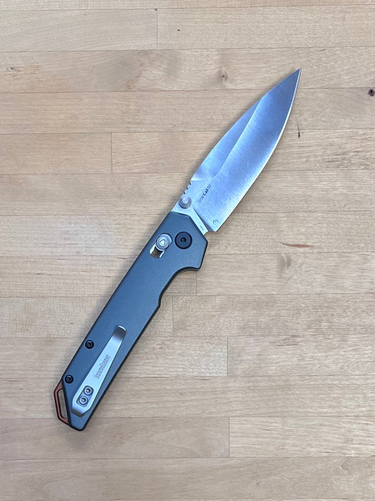 Folding knife on a wooden surface