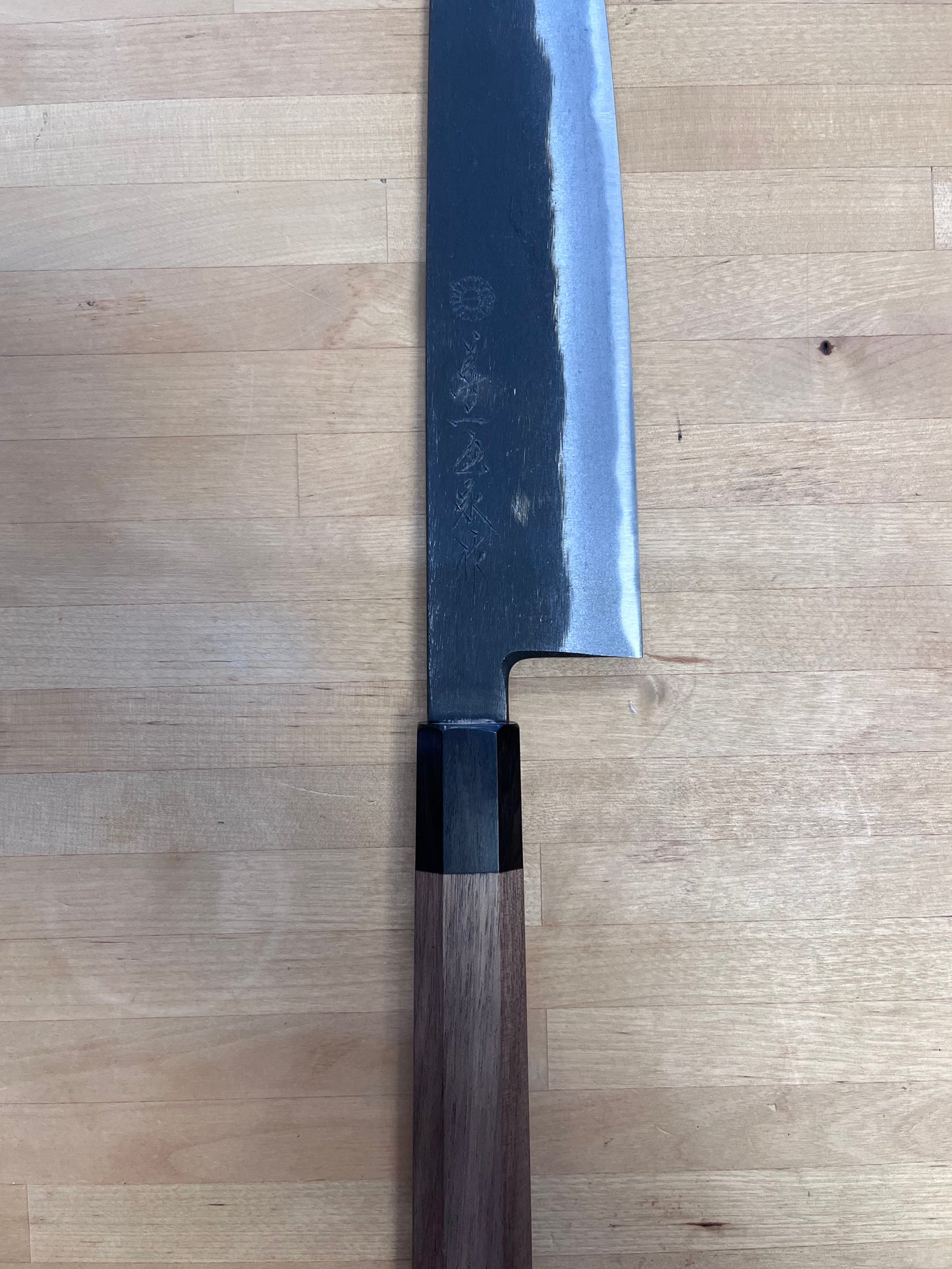 Close up of Kuro Gyuto on butcher block