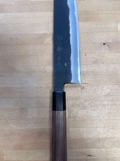 Close up of Kuro Gyuto on butcher block