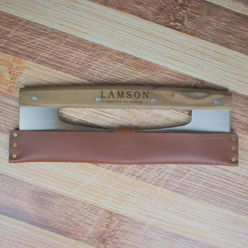 Lamson Rocker Cutter with leather sheath on butcher block.
