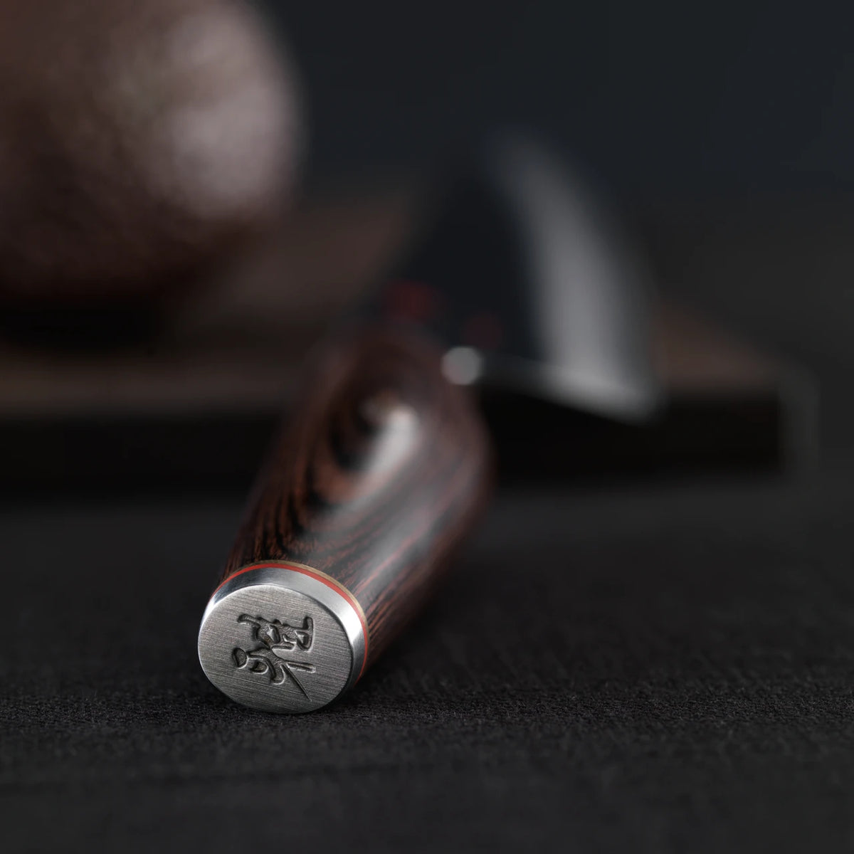 Focused picture of engraved pommel of the knife handle.