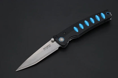 A folding pocket knife with a satin finish stainless steel blade and a black handle featuring bright blue accents, shown on a dark gray background.