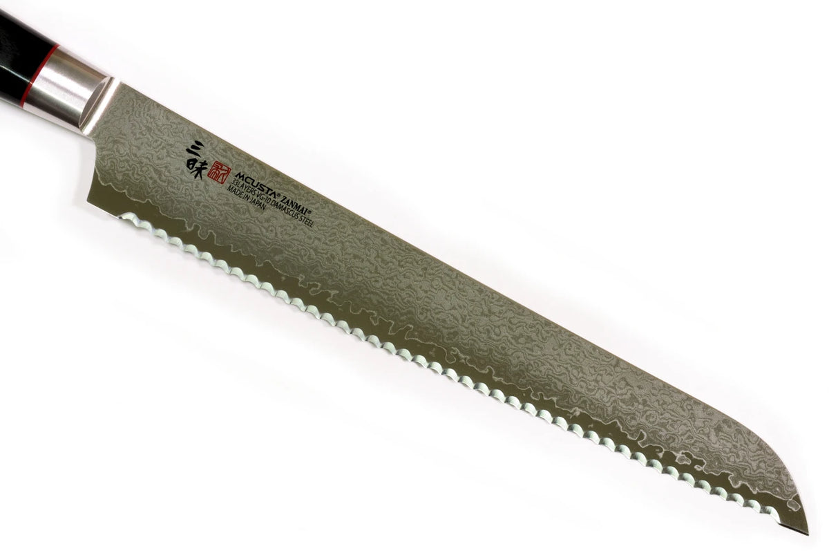 A Japanese bread knife with a Damascus steel blade and a black handle, shown diagonally on a plain white background.
