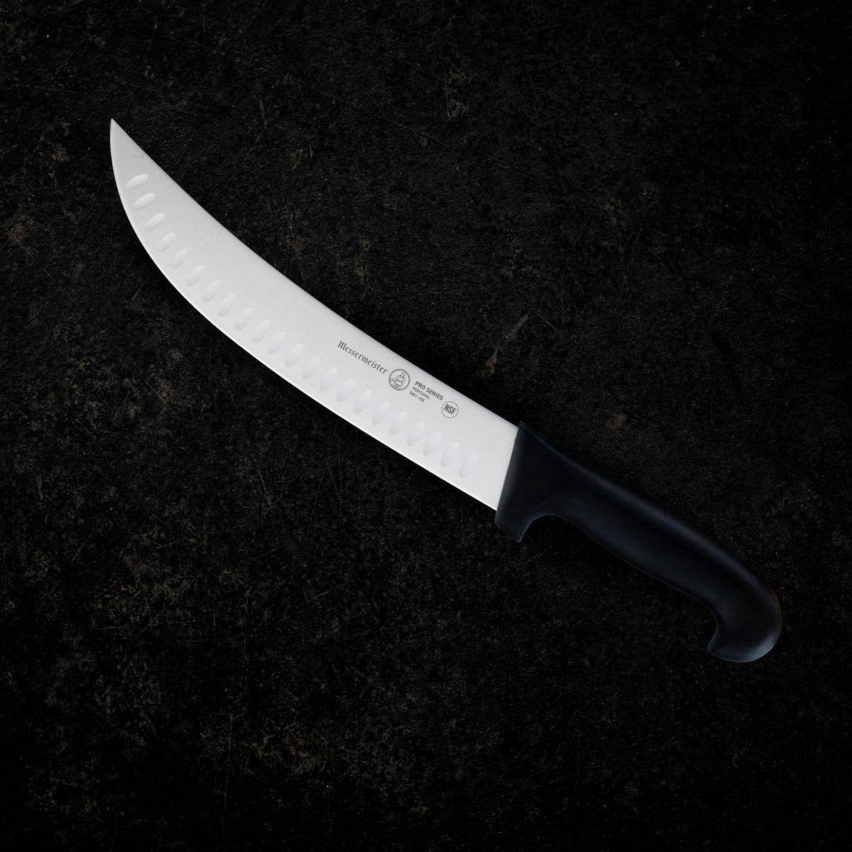 Scimitar knife with a black handle on a dark textured background