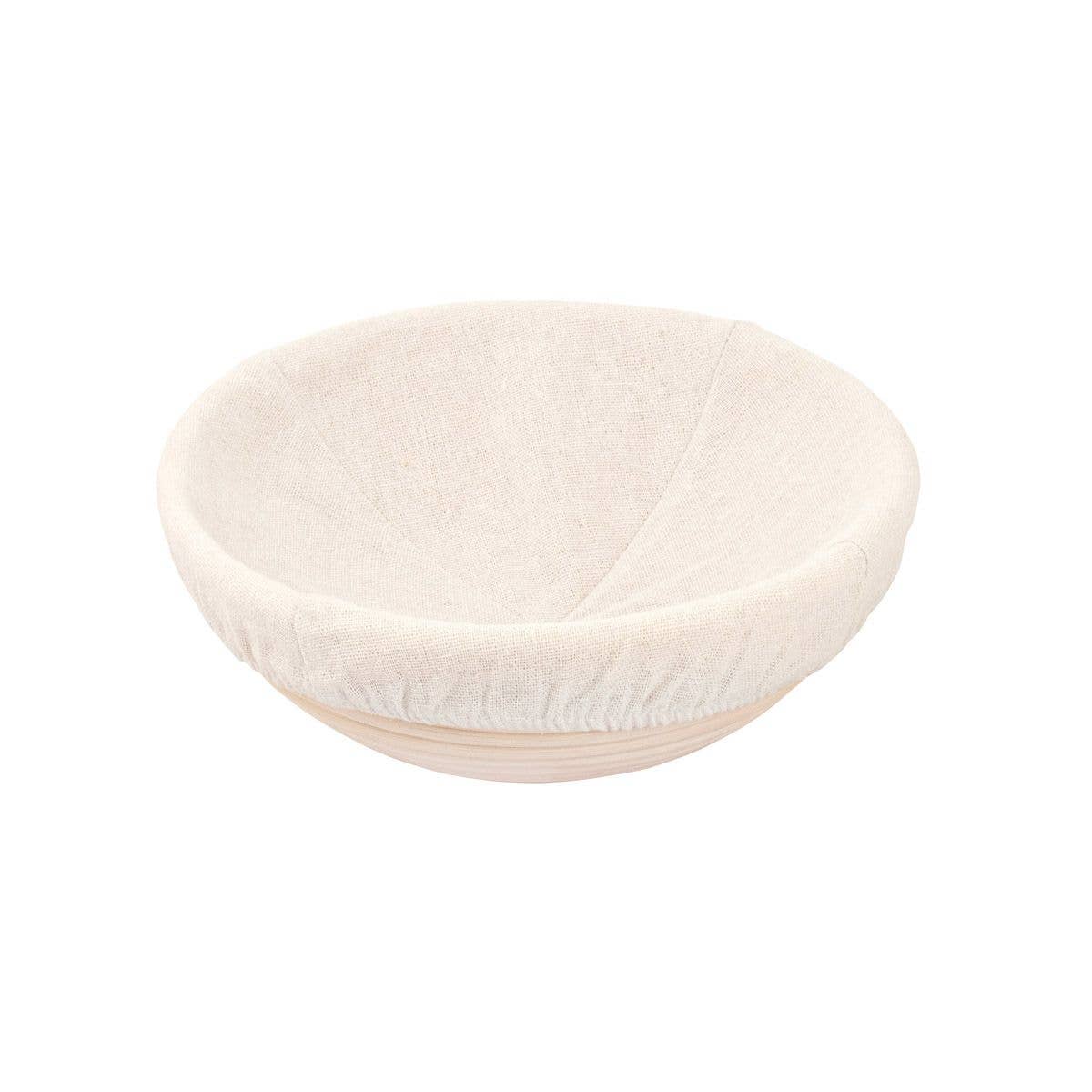 Round proofing basket with a white fabric liner on a white background