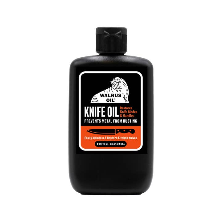 Black bottle of Walrus Oil Knife Oil on a white background